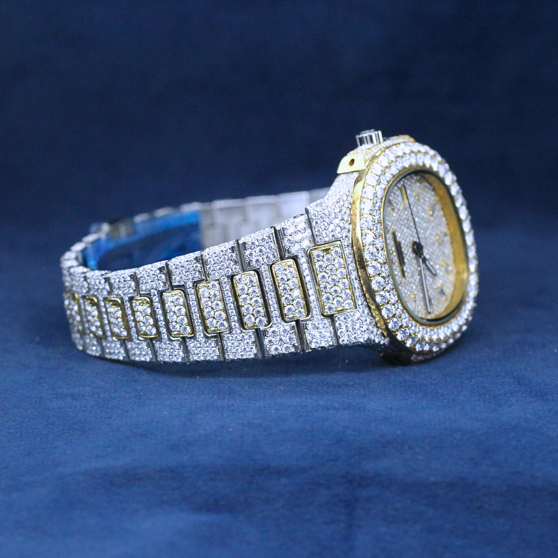 A right-side view of a custom iced-out hip-hop watch featuring a two-tone design with an iced-out bezel and Moissanite diamond-studded band.