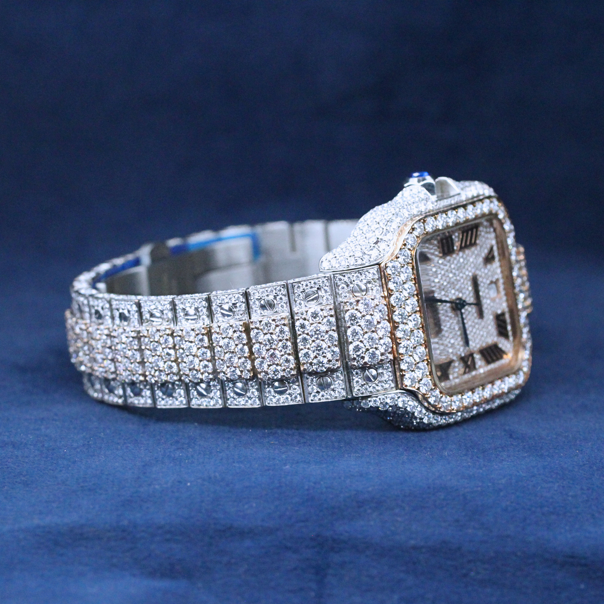 A left-side view of a custom iced-out hip-hop watch with a bold square face, showcasing Moissanite diamonds covering the case and band.