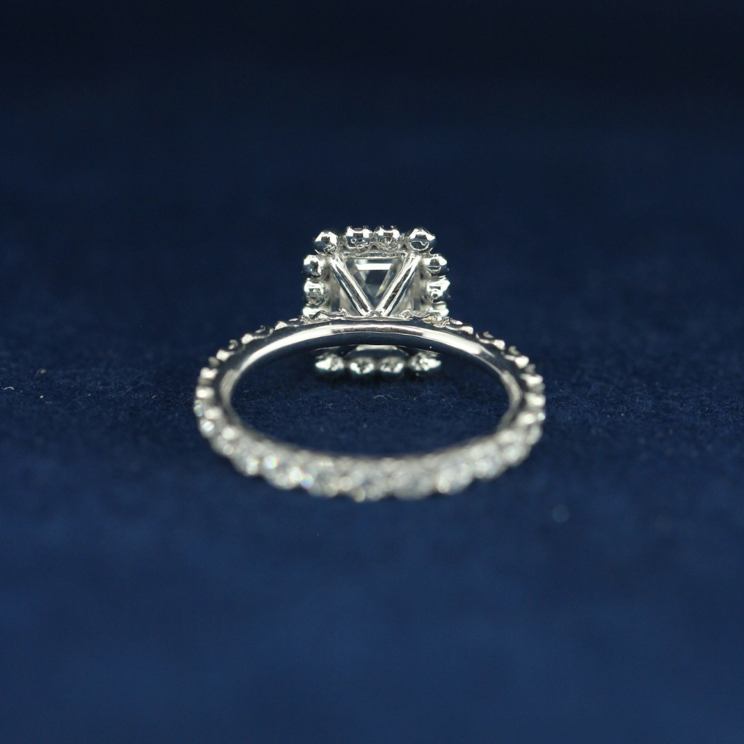 A back-side view of a fine jewelry emerald diamond ring in 925 sterling silver, highlighting its smooth, polished finish and premium quality.