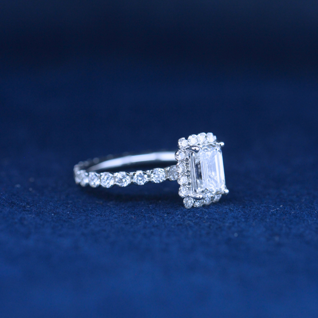 A left-side view of a fine jewelry emerald diamond ring in 925 sterling silver, designed with timeless elegance and a radiant diamond.