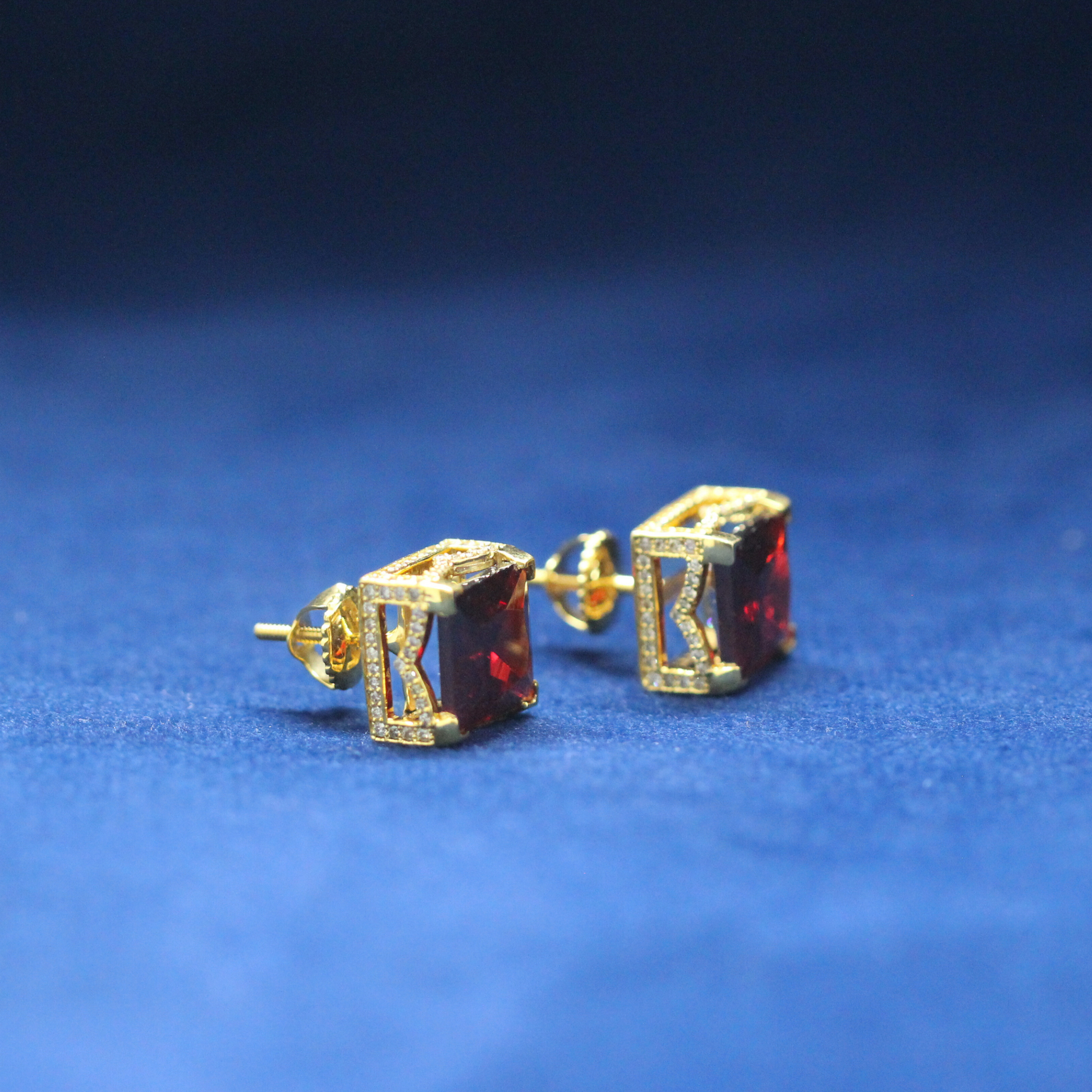 Left-side view of Ruby Cube Studs earrings in 925 silver, encrusted with radiant Moissanite diamonds and a stunning ruby stone for an iced-out hip-hop look.