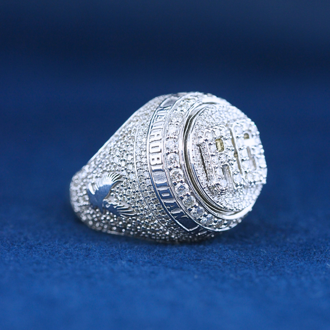 "A close-up zoom view of a hip-hop jewelry RC Championship ring in 925 sterling silver, showcasing its dazzling diamonds and bold engraving.