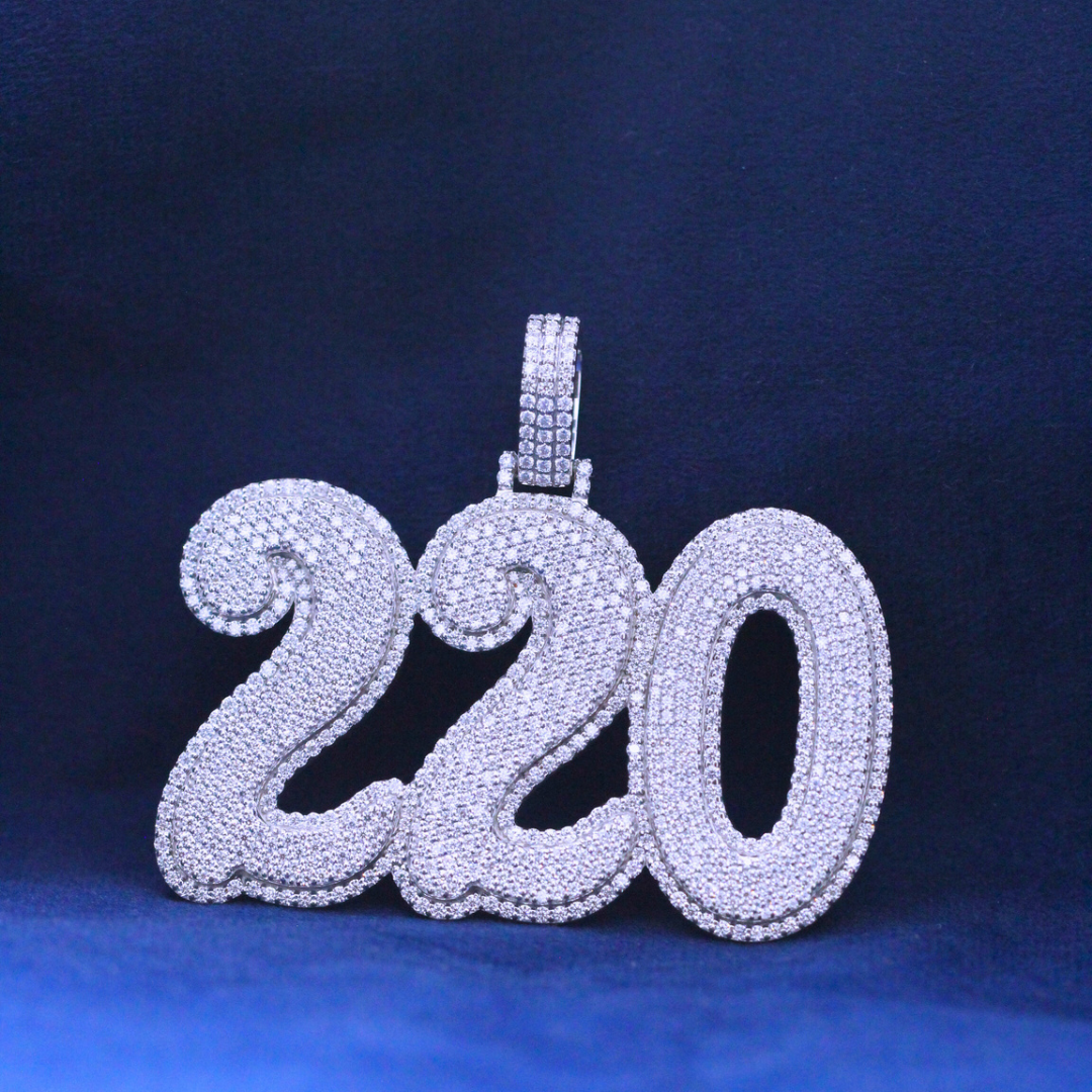 Close-up zoomed view of Two-Twenty Luxe Pendant in 925 silver, showcasing its intricate details and iced-out Moissanite diamonds for hip-hop fashion.