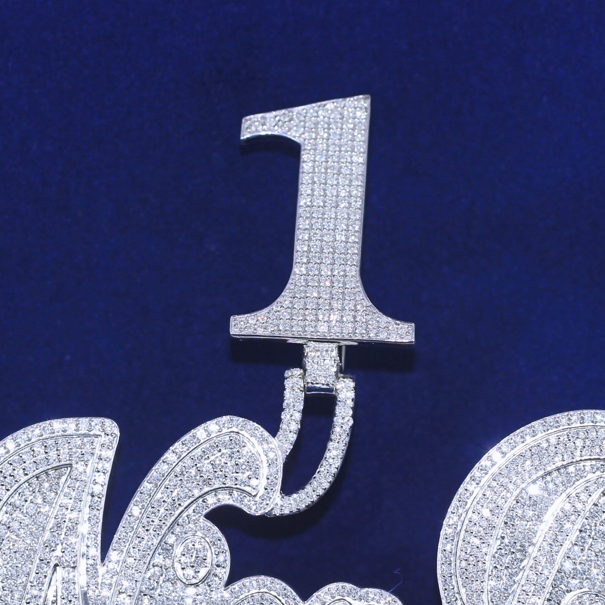 Close-up zoom view of Number 1 Nica B Diamond Pendant, showcasing the brilliance of moissanite diamonds and intricate hip-hop jewelry craftsmanship.Close-up zoom view of Number 1 Nica B Diamond Pendant, showcasing the brilliance of moissanite diamonds and intricate hip-hop jewelry craftsmanship.