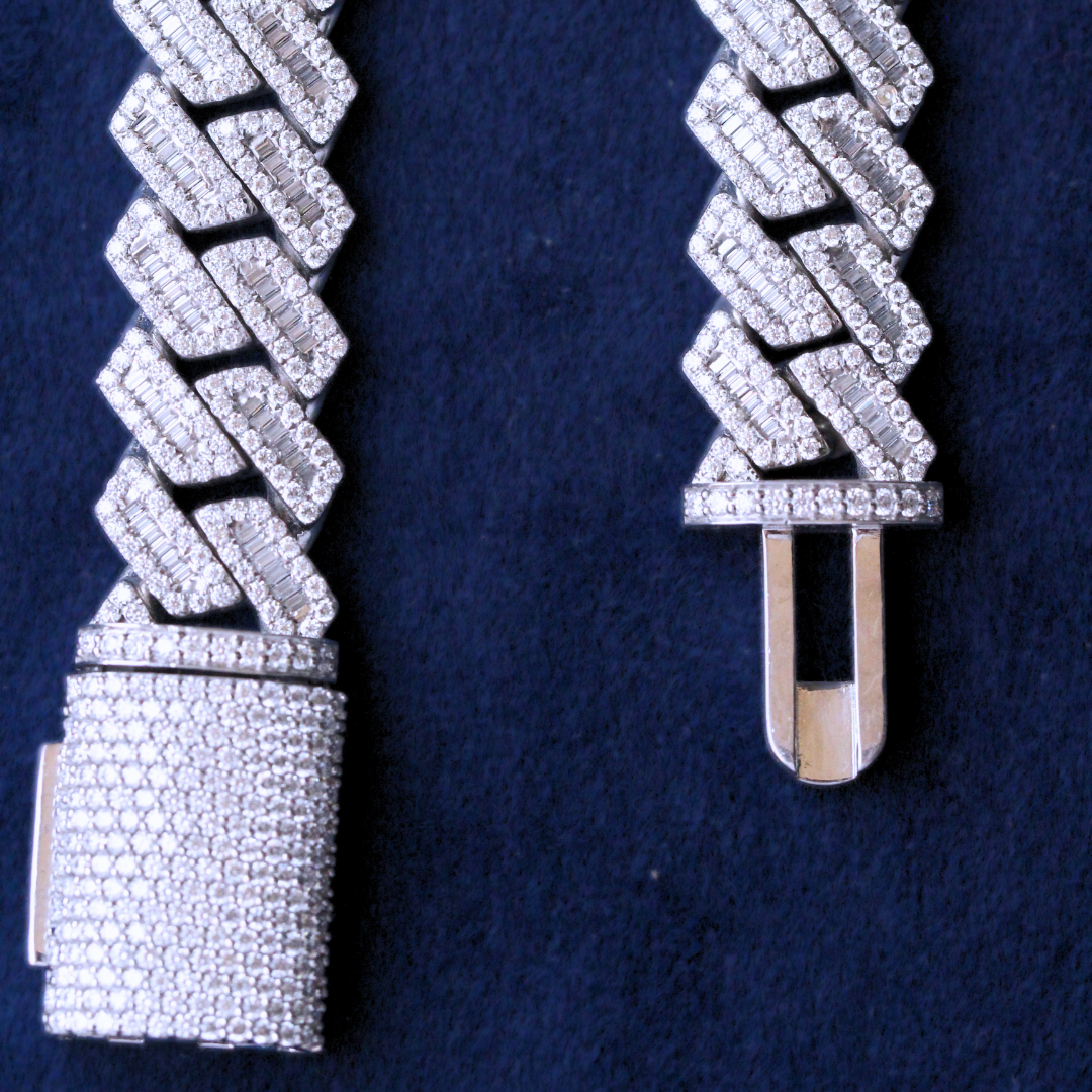Zoomed-in view of the open lock mechanism on a Cuban link chain, featuring 925 silver and moissanite diamonds, showcasing craftsmanship and clasp design in high-end hip hop jewelry.