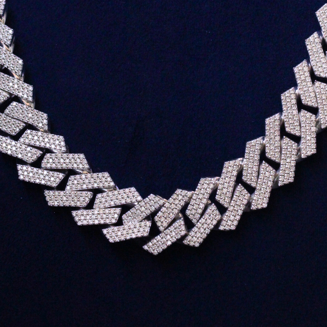 Close-up of Cuban link chain detail highlighting moissanite diamond sparkle in 925 silver, luxury fine jewelry.