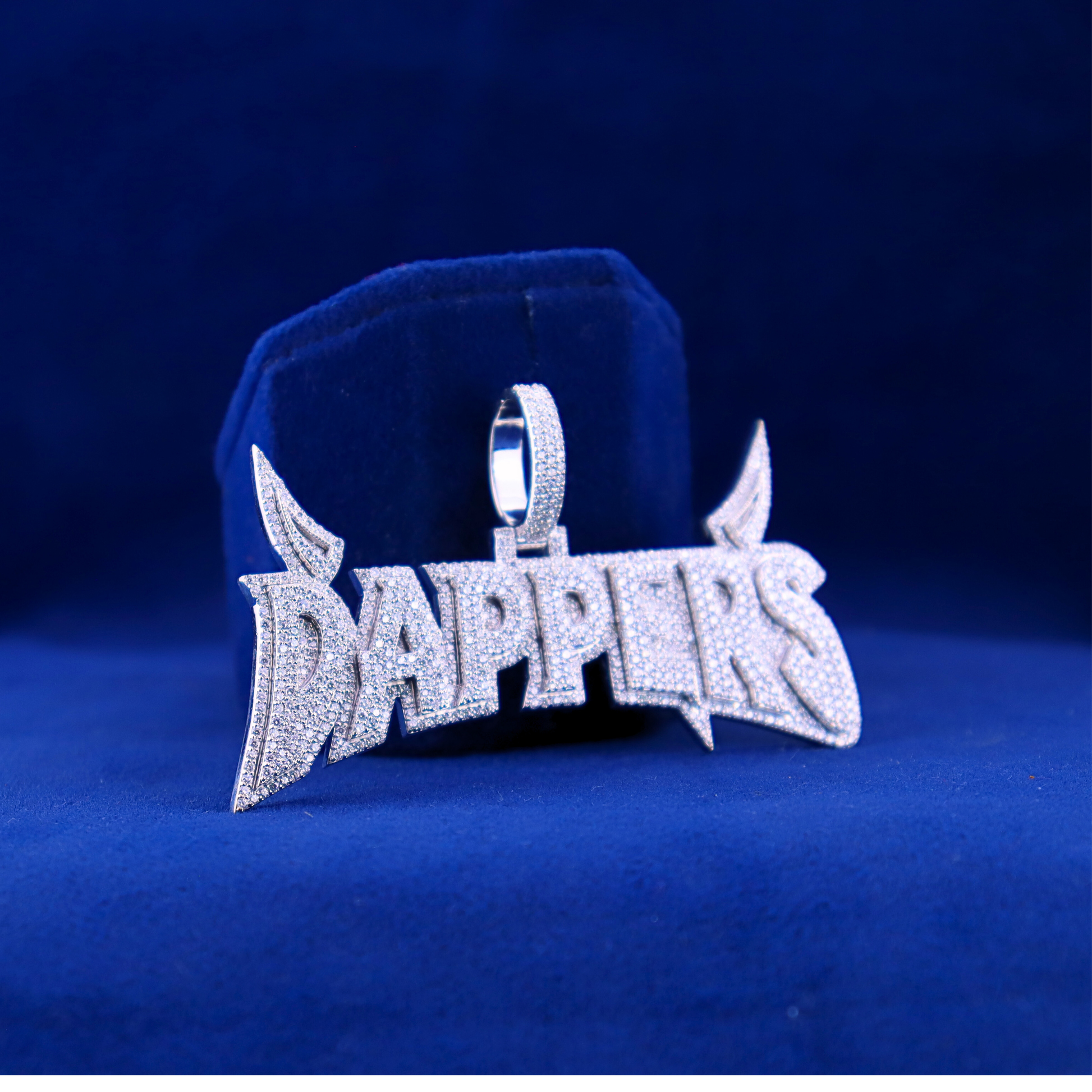 Right angle view of Dappers iced-out pendant, crafted in 14K silver and moissanite, complementing a half iced out custom watch