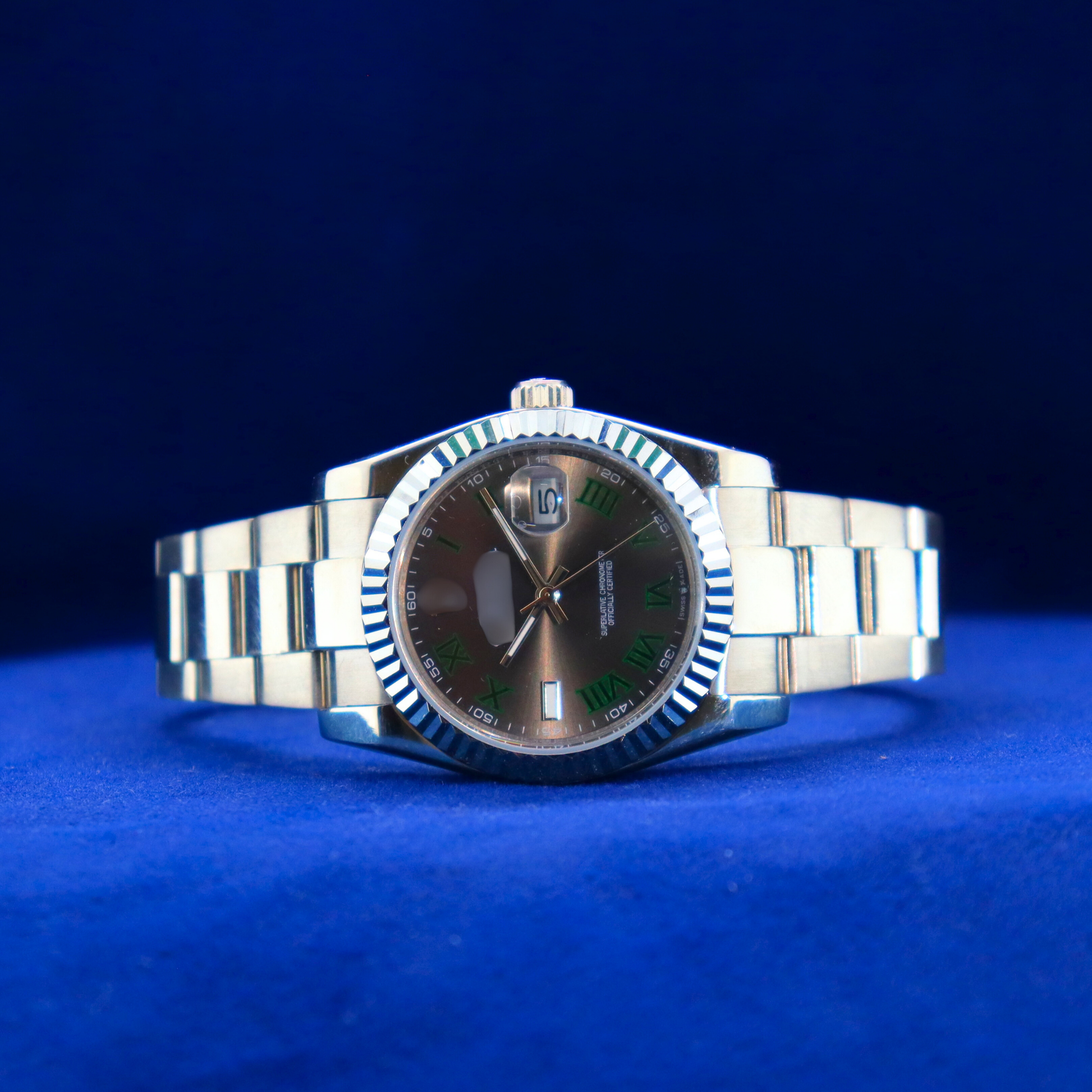 Front view of sunburst black-green dial half iced out custom watch with stainless steel case and luxury design