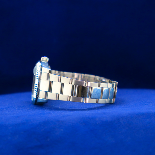 Left side view of luxury sunburst black-green dial watch, half iced out custom style with premium details