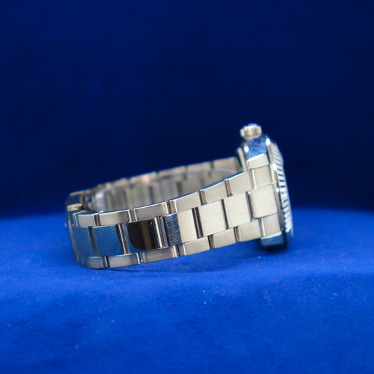 Right side view of elegant sunburst blue dial half iced out custom watch with polished silver accents