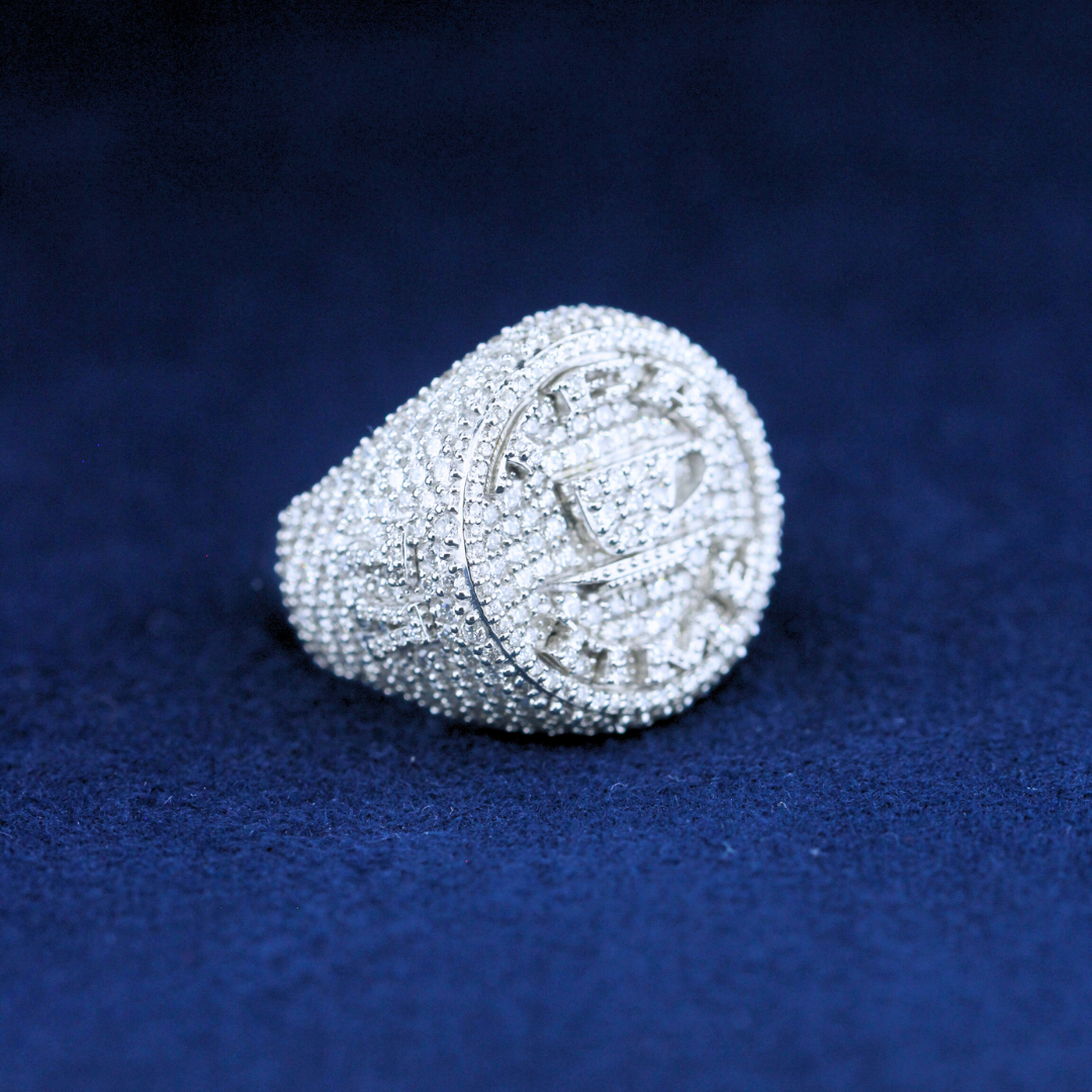 A bold fine jewelry championship ring in 925 sterling silver, featuring dazzling moissanite diamonds and an intricate championship-inspired design.