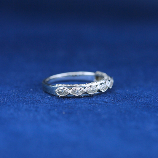 A left-side view of a fine jewelry 7 marquise diamond ring in 925 sterling silver, highlighting its elegant structure and sparkling diamonds.