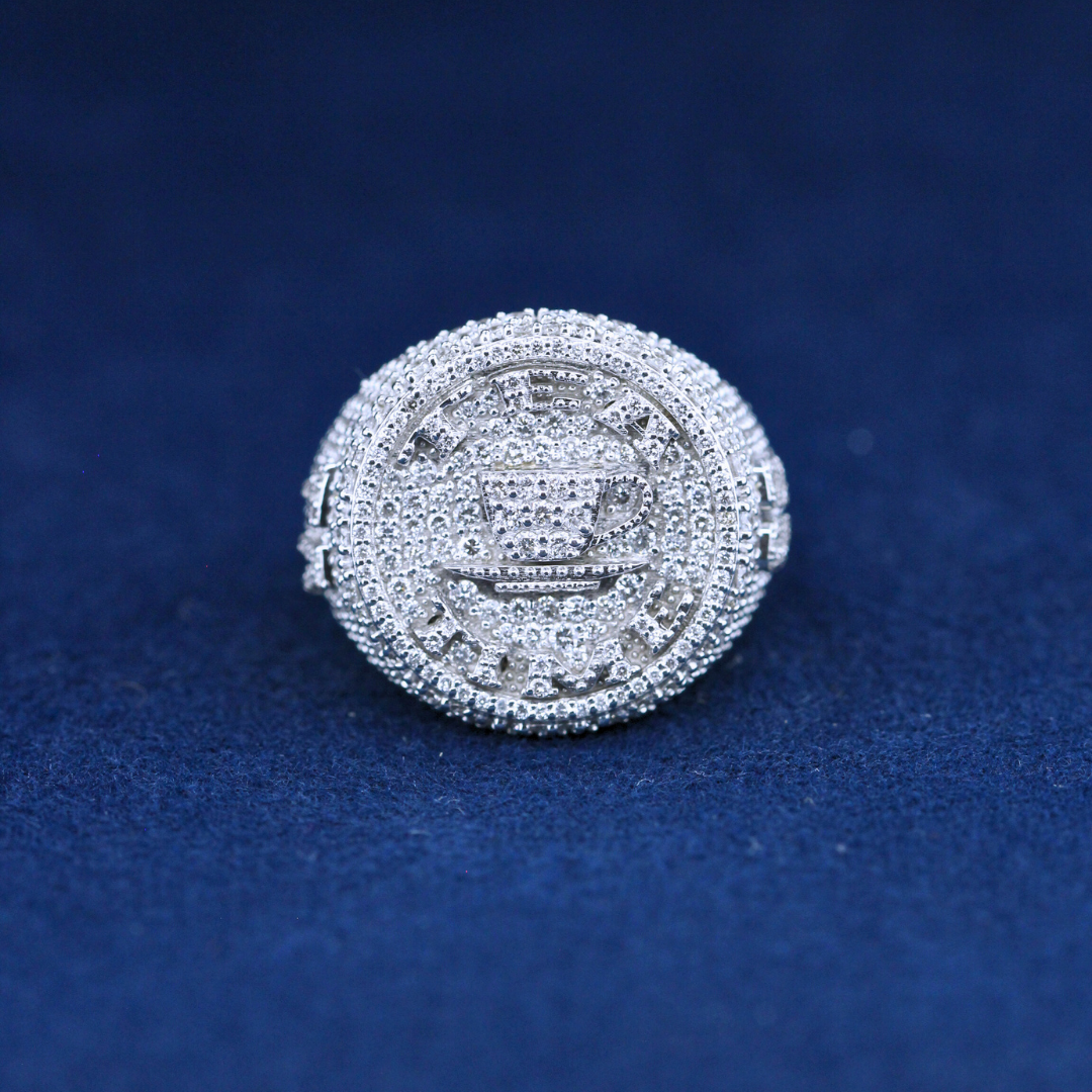 A bold fine jewelry championship ring in 925 sterling silver, featuring dazzling moissanite diamonds and an intricate championship-inspired design.