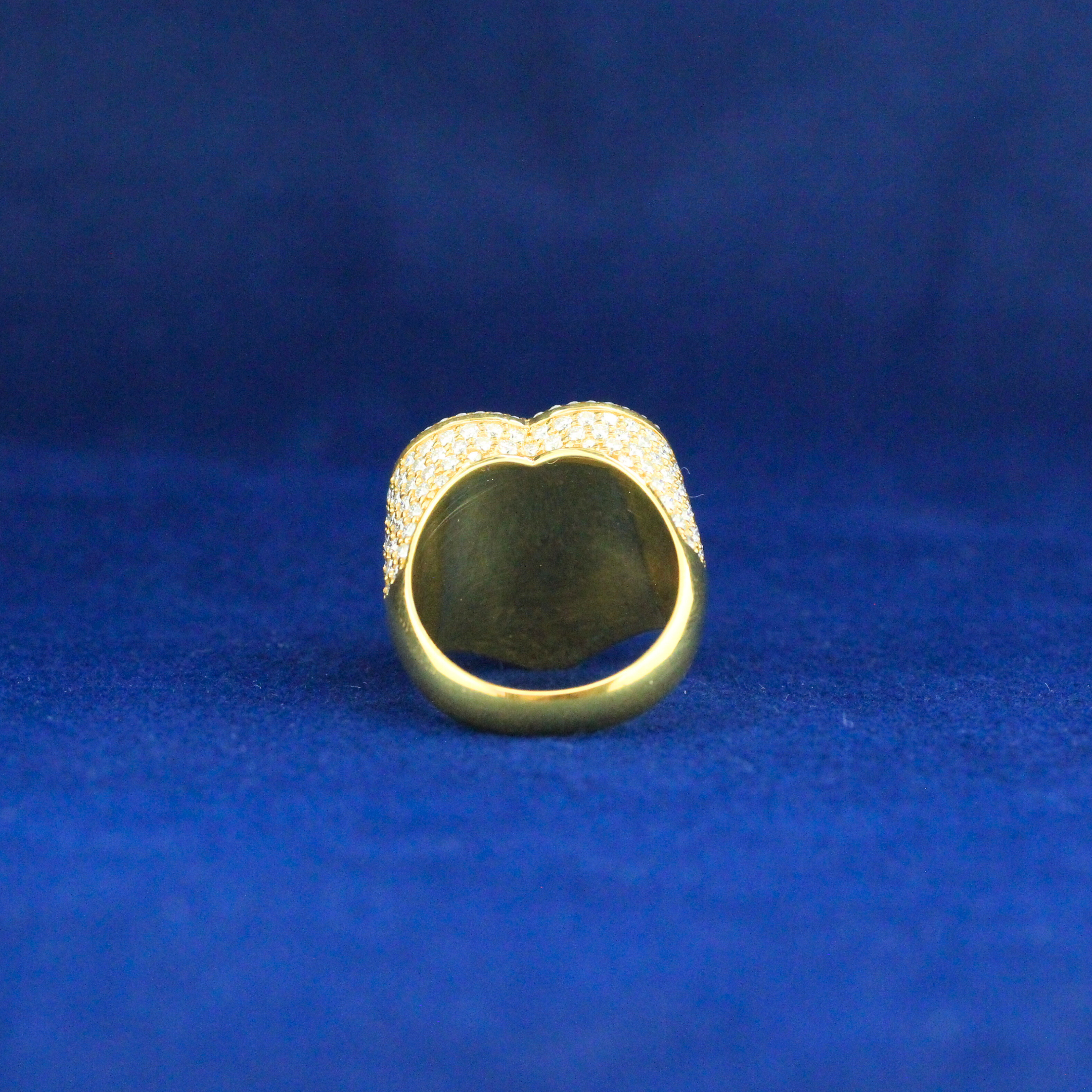 Back view of heart-shaped gold ring with moissanite stones, high-end hip hop jewelry style.

