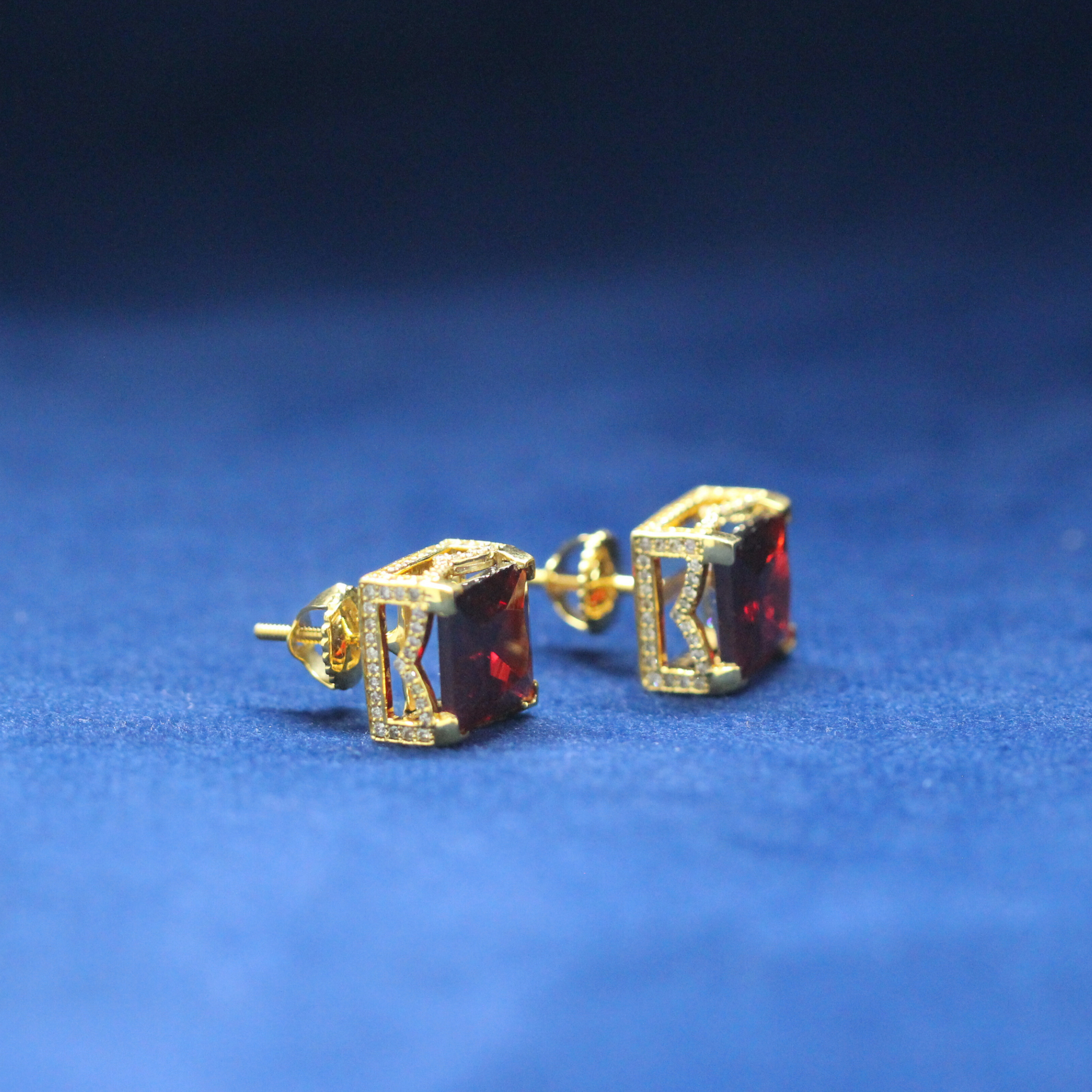 Left-side view of Ruby Cube Studs earrings in 925 silver, encrusted with radiant Moissanite diamonds and a stunning ruby stone for an iced-out hip-hop look.