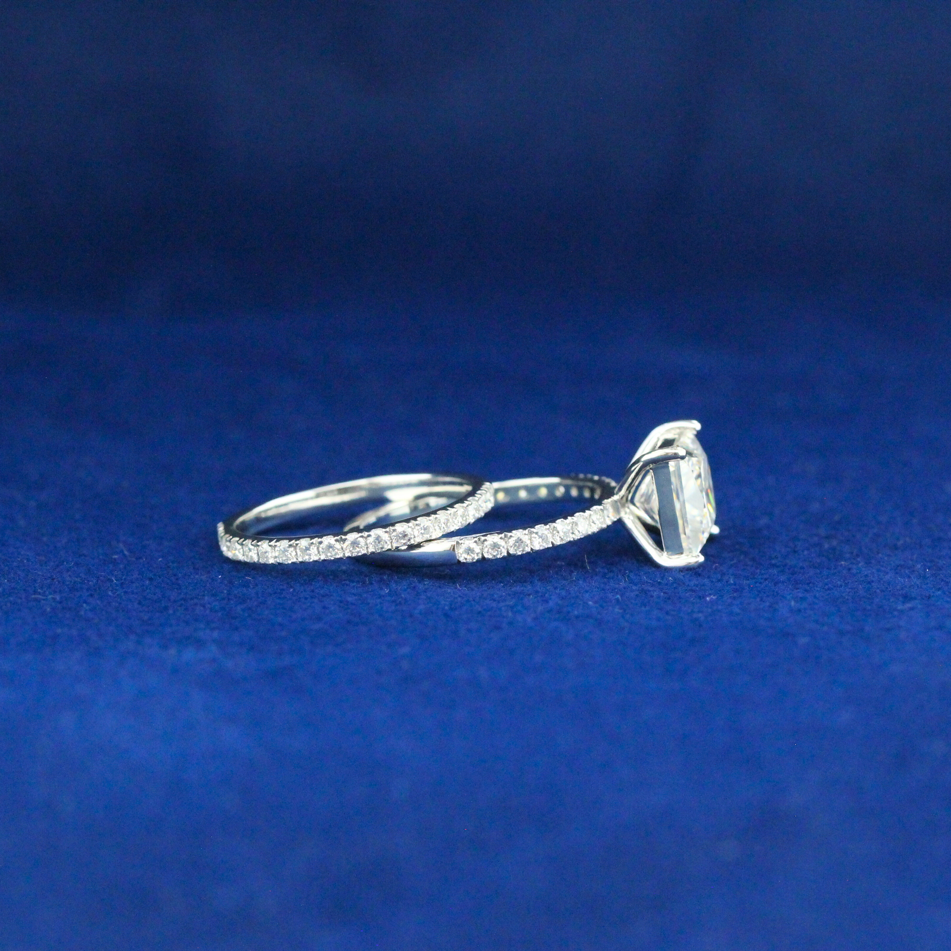 Right angle of sparkling moissanite princess ring set in 925 silver, royal-inspired fine jewelry piece.

