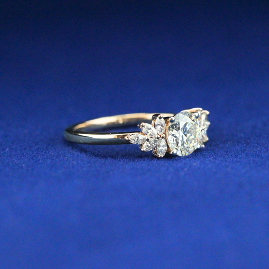 Left side of round cluster moissanite diamond ring highlighting its brilliant cut and luxury design.

