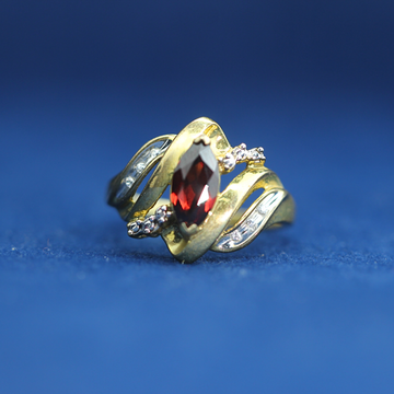 Front view of preowned garnet gold ring crafted in 14K silver with moissanite diamonds – luxury vintage style that pairs with half iced out custom jewelry