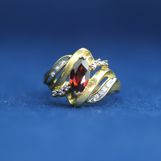 Front view of preowned garnet gold ring crafted in 14K silver with moissanite diamonds – luxury vintage style that pairs with half iced out custom jewelry
