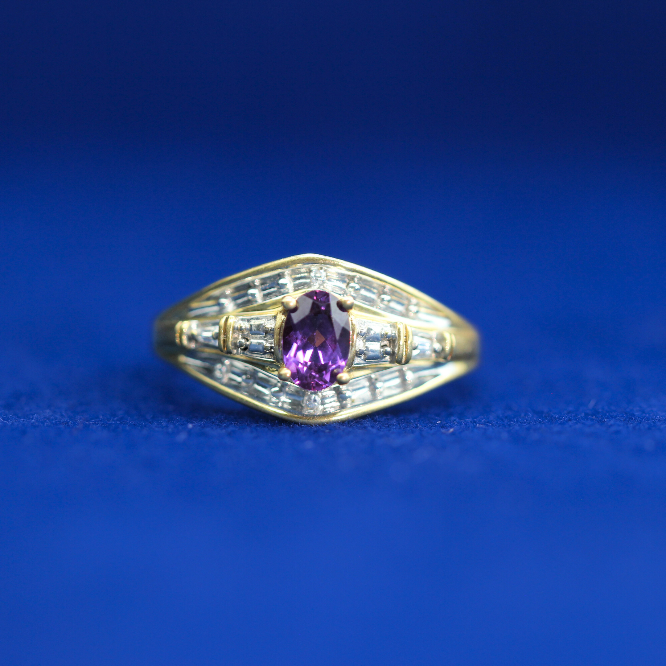 Front view of gold pink sapphire baguette ring in 14K silver with moissanite diamonds – elegant luxury piece styled with half iced out custom jewelry.
