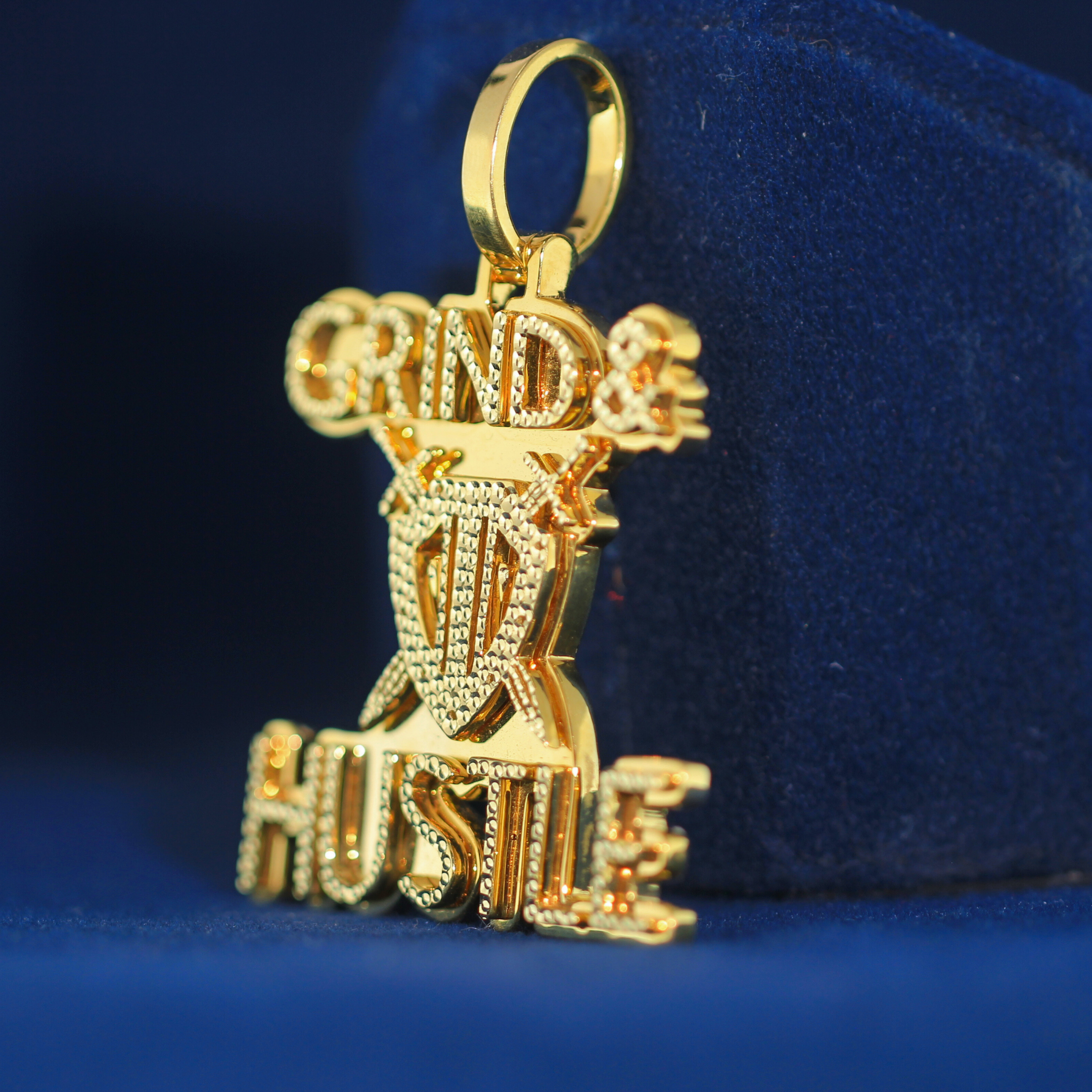 Left-side view of GRIND & HUSTLE pendant in high-quality 925 silver, featuring a luxury MOISSANITE diamond setting.

