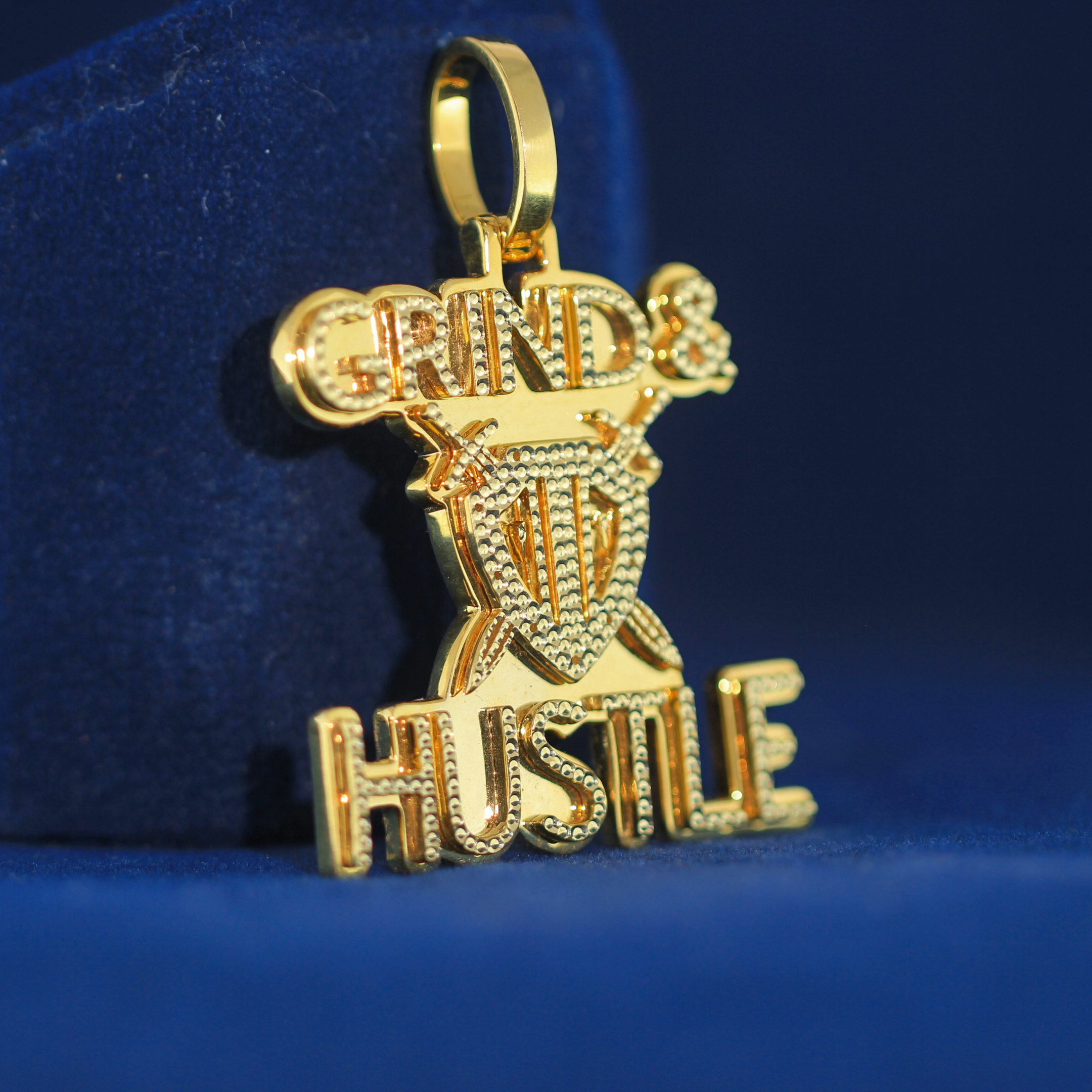 Right-side view of GRIND & HUSTLE pendant, crafted from 925 silver and iced out with MOISSANITE diamonds.

