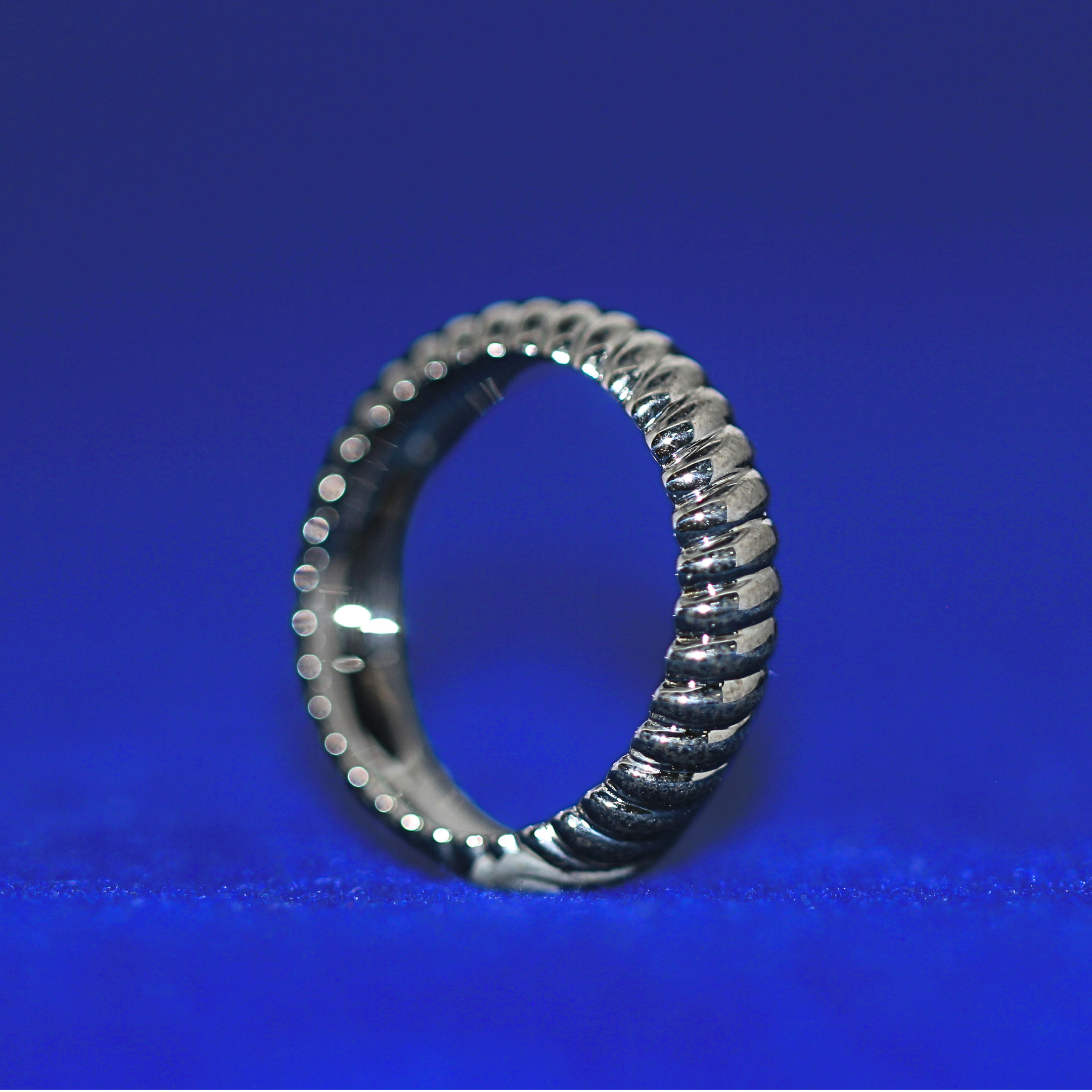 Right angle of 14K silver Infinity Wedding Band with moissanite stones, complements custom half iced out watch styles
