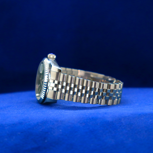 Left side view of green dial luxury watch with half iced out custom design and premium case finish

