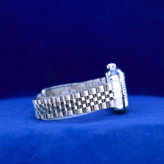 Right side view of sleek light-blue dial watch, half iced out custom style with polished silver bezel

